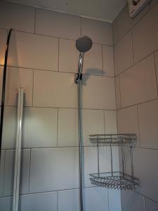 a shower with a shower head in a bathroom at i Amazing 5 Beds Sleeps 5 Workers Or Families by Your Night Inn Group in Wolverhampton