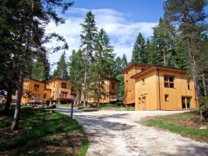 a group of wooden houses in a forest at Forest Chalet Resort FELIZITAS in San Felice