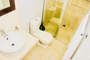 a bathroom with a toilet and a sink and a shower at Superior Studio 20 Aquamarina Suites in Playa del Carmen