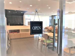 a sign that says open hanging in a restaurant at Smile Hotel Mito in Mito