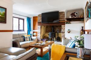 a living room with a couch and a fireplace at Herefordshire Holiday Cottages in Lea