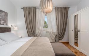 a bedroom with a bed and a large window at Rooms Porto in Savudrija