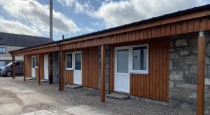 a row of doors and windows on a building at Ivy Cottage-Serviced accommodation in Dyce