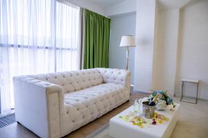 a living room with a white couch and a table at BLISS HOTEL & SPA in Kirov