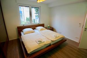 a bedroom with a large bed with a window at Porschenahe Wohung in Stuttgart