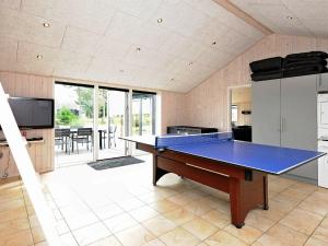 a ping pong table in the middle of a room at Four-Bedroom Holiday home in Rømø 5 in Rømø Kirkeby
