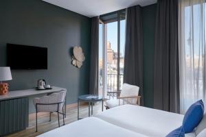 a hotel room with a bed and a window at Vincci Selección Posada del Patio in Málaga