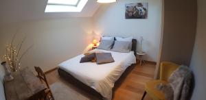 a bedroom with a bed with white sheets and a window at Manou du Lac Annecy in Doussard +73 photos