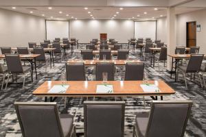 an empty conference room with tables and chairs at Holiday Inn Portland- I-5 S Wilsonville by IHG in Wilsonville +38 photos