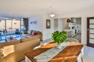 a living room with a couch and a table at 302 Kenwyn on Sea- Luxury Beachfront Getaway in Ballito