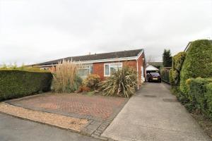 a house with a brick driveway in front of it at Spacious bungalow/private garden-sleeps up to 6 in Marple