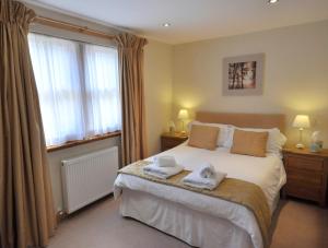 a bedroom with a large bed with two towels on it at Chapel of Barras B&B in Stonehaven