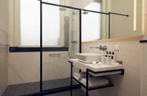 a bathroom with a sink and a shower at Hotel New York by WestCord in Rotterdam