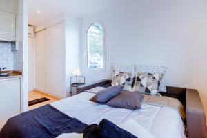 a bedroom with a large bed with pillows on it at Brand New Studio, Sea View, AirCon, Wifi in Roquebrune-Cap-Martin