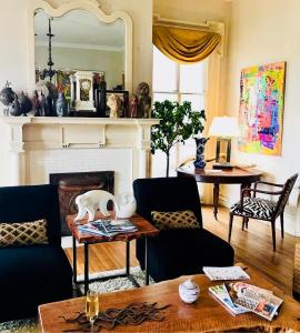 a living room with a fireplace and a table at Elmwood 1820 Bed & Breakfast Inn in Washington