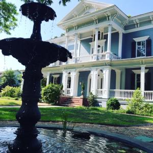 a large house with a fountain in front of a house at Elmwood 1820 Bed & Breakfast Inn in Washington