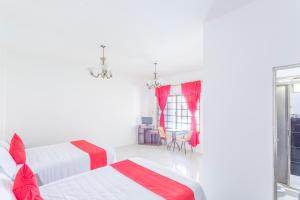 a white room with two beds and a window at OYO Hotel Rio in Subteniente López