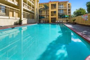 a large blue swimming pool in a apartment building at La Quinta Inn by Wyndham San Diego - Miramar in Sabre Springs