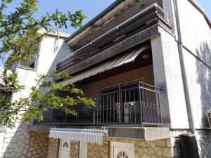 a building with a balcony on the side of it at Apartman Mimi in Klenovica