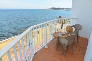 a balcony with a table and chairs and the ocean at Rallye Hotel in L'Escala