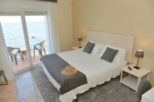a bedroom with a bed with a hat on it at Rallye Hotel in L'Escala
