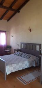 a bedroom with a large bed and a window at Anemos in Afionas