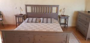a bedroom with a large bed with two night stands at Anemos in Afionas