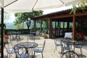 a group of tables and chairs in a patio at Agriturismo La Solagna in Montebello di Bertona