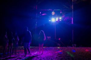 a group of people standing in front of a stage at Escapism Maldives in Feridhoo