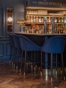 a bar with blue stools in front of a counter at The Wilder in Dublin