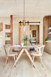 a dining room with a wooden table and chairs at Lindeborgs Eco Retreat in Vrena