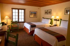 a hotel room with two beds and two lamps at Inn on the Alameda in Santa Fe