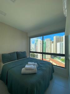 a bedroom with a bed with towels on it at Apartamento de Luxo em Boa Viagem Perto da Praia. in Recife +21 photos