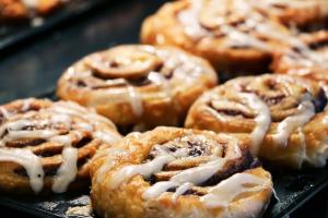 a bunch of donuts with icing on a tray at Holiday Inn Express Ontario by IHG in Creekside +41 photos