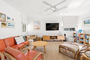 a living room with a couch and a table at Florida on Carlyle Street in Byron Bay