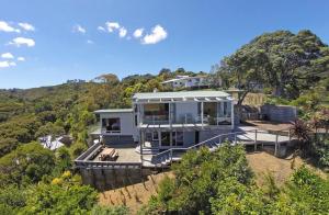 a house on top of a hill with trees at Vista Twenty One in Onetangi