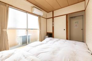 Ліжко або ліжка в номері Tabist Business Ryokan Akashiya Annex