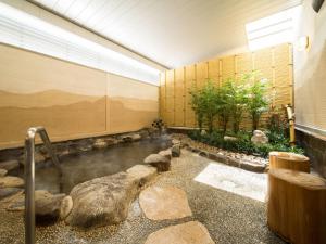 an outdoor area with benches and plants at Super Hotel Lohas JR Nara Eki in Nara