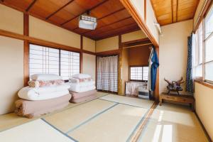 a room with three mattresses on the floor at 古民家一棟貸しの宿 Thank you Hippo Inn in Matsumoto