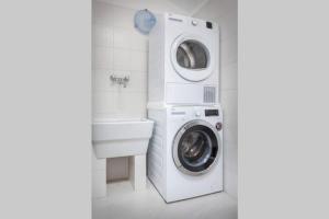 サン・ピエトロ・イン・カリアーノにあるCasa San Floriano-In Valpolicellaの洗濯機と洗面台を備えたバスルーム