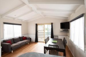 ein Wohnzimmer mit Couch und Tisch in der Unterkunft Crestview Tourist Park in Queanbeyan