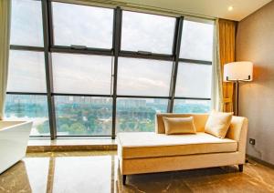 a room with a couch and large windows at Ramada Plaza by Wyndham Nanxun in Huzhou