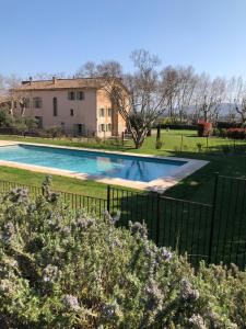 a swimming pool in front of a house at Château des Demoiselles in La Motte
