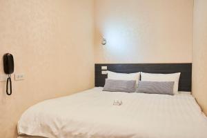 Postel nebo postele na pokoji v ubytování Place‧X Hotel