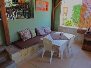 a table and chairs and a couch on a patio at Julia Hotel in Fourka