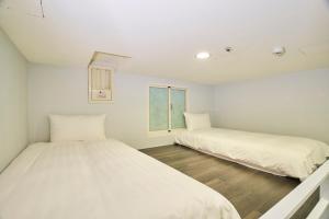 Postel nebo postele na pokoji v ubytování Place‧X Hotel