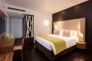 a hotel room with a large bed and a desk at Campanile Marseille Est - Aubagne in Aubagne +17 photos