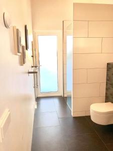 a bathroom with a toilet and a window at Golden Circle Luxury Villa in Selfoss