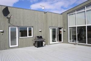 a building with windows and a desk in front of it at Golden Circle Luxury Villa in Selfoss