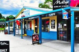 a row of stores with signs in front of them at BIG4 Strahan Holiday Retreat in Strahan